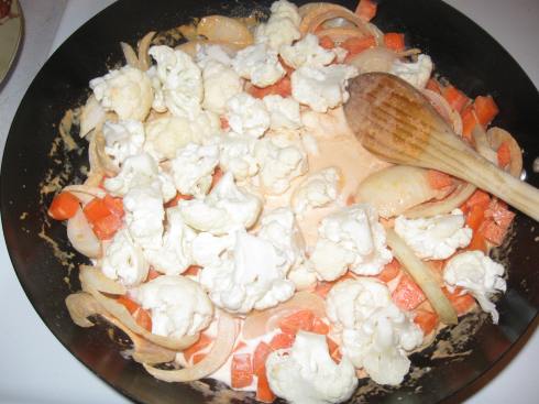 Add cauliflower florets, onions and diced carrots . . .